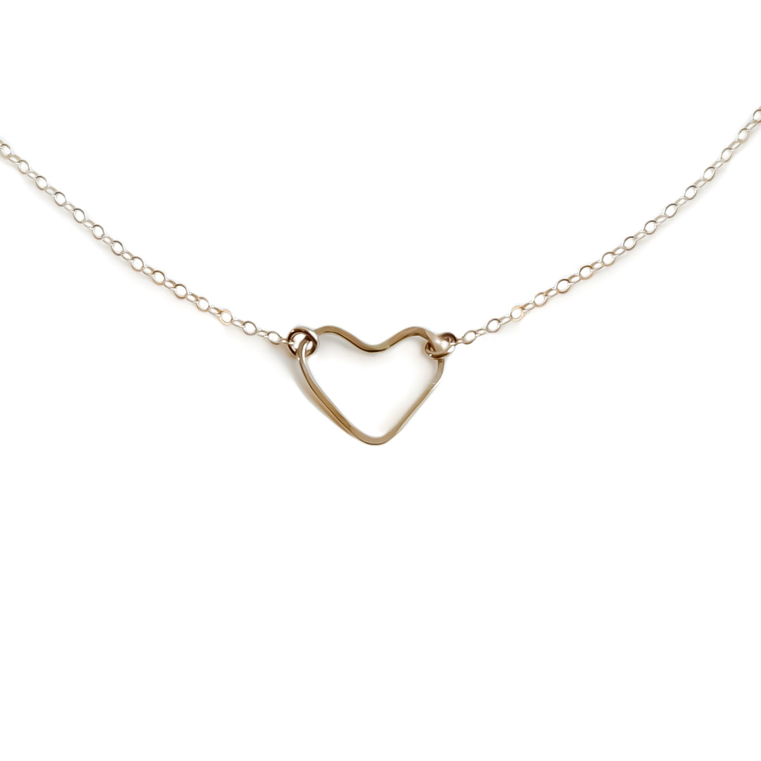 A gold-colored open heart-shaped necklace on a chain, displayed against a white background.