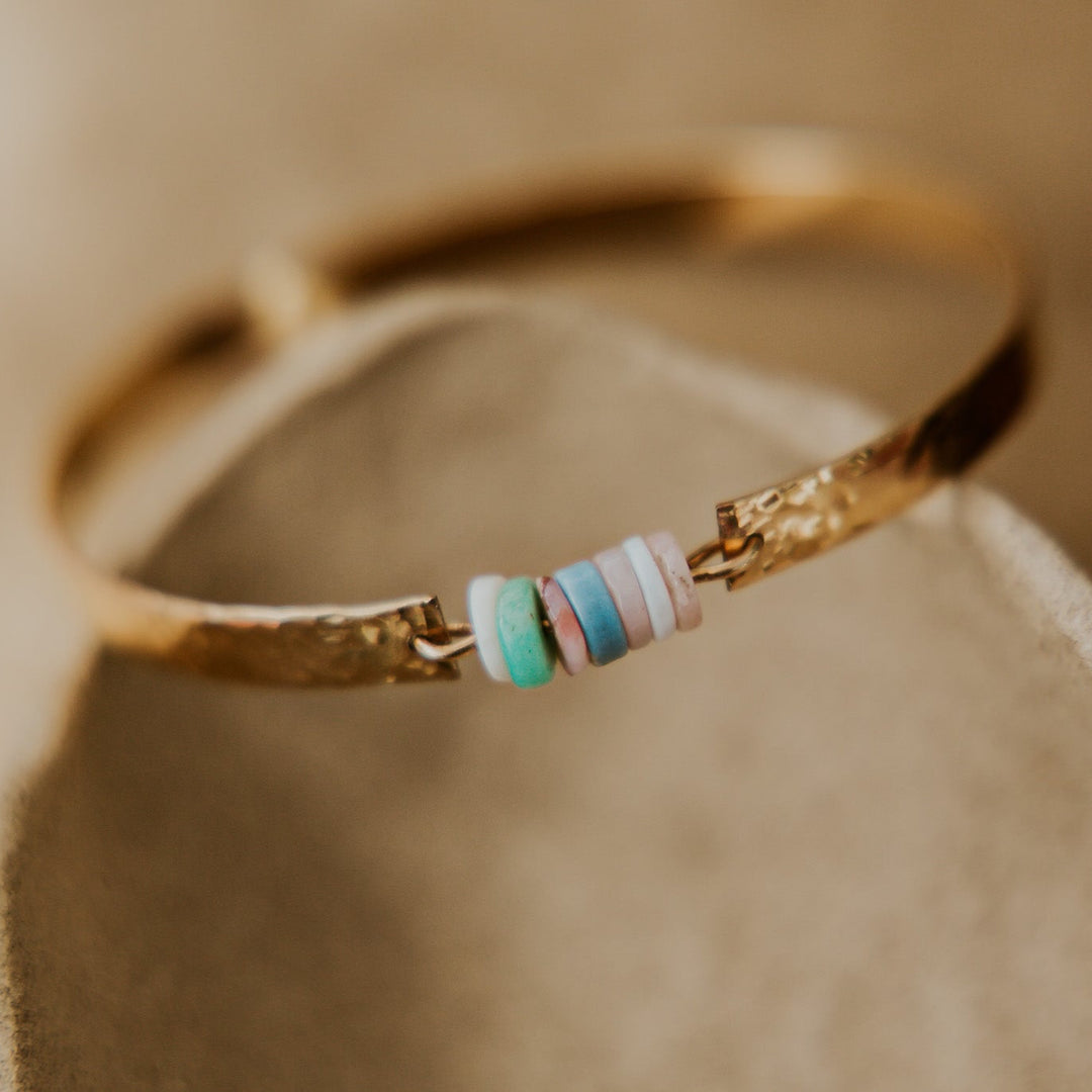 gold textured bangle with natural stones slices in the middle 