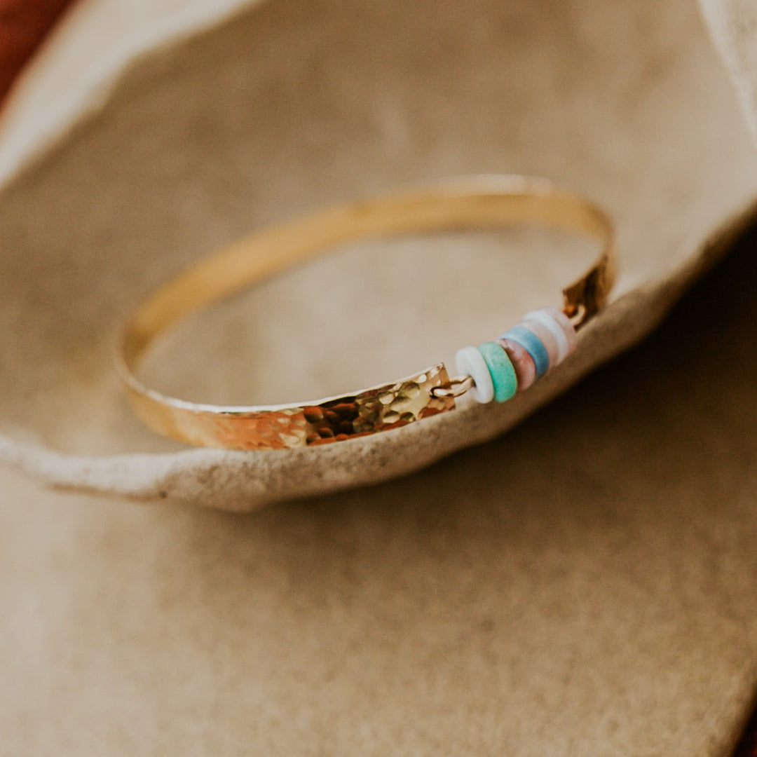 14k gold plated textured bangle with natural stones in the middle 