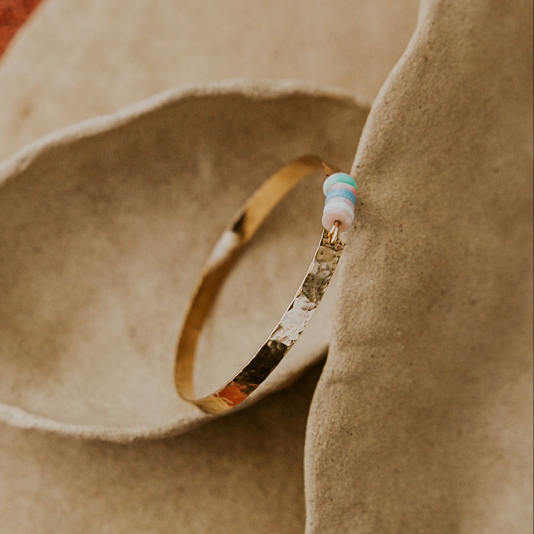 14k gold plated hammered bangle with natural stones in the middle