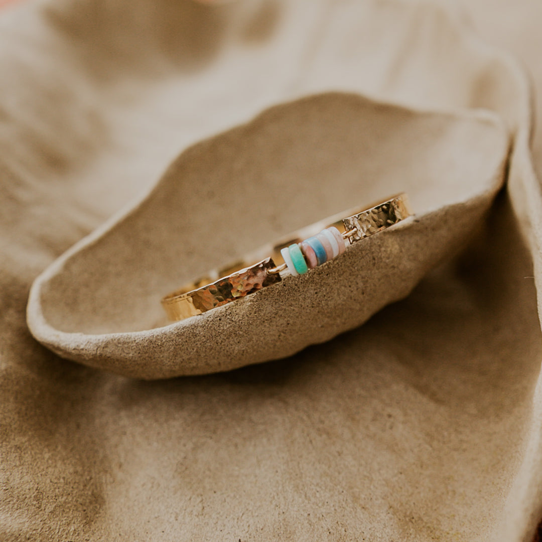 14k gold plated hammered textured bangle with natural stones in middle