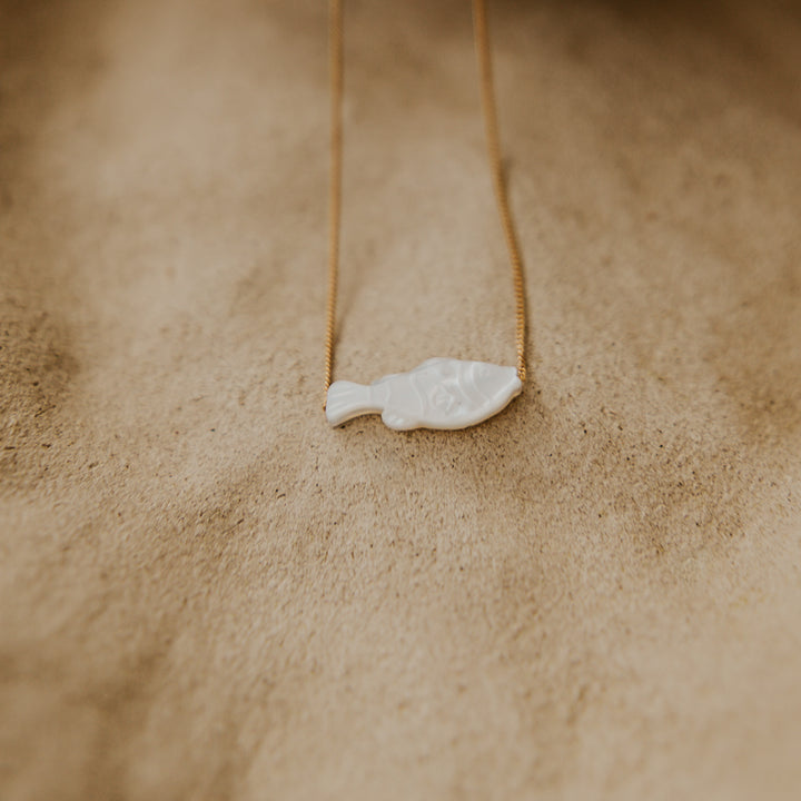 mother of peal fish pendent on thin 14k gold platted chain