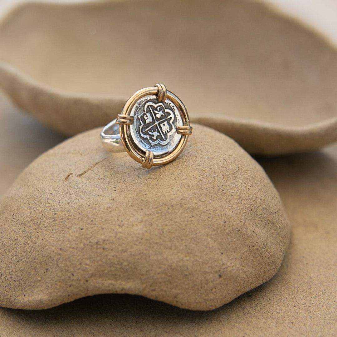 old silver coin ring with gold around it