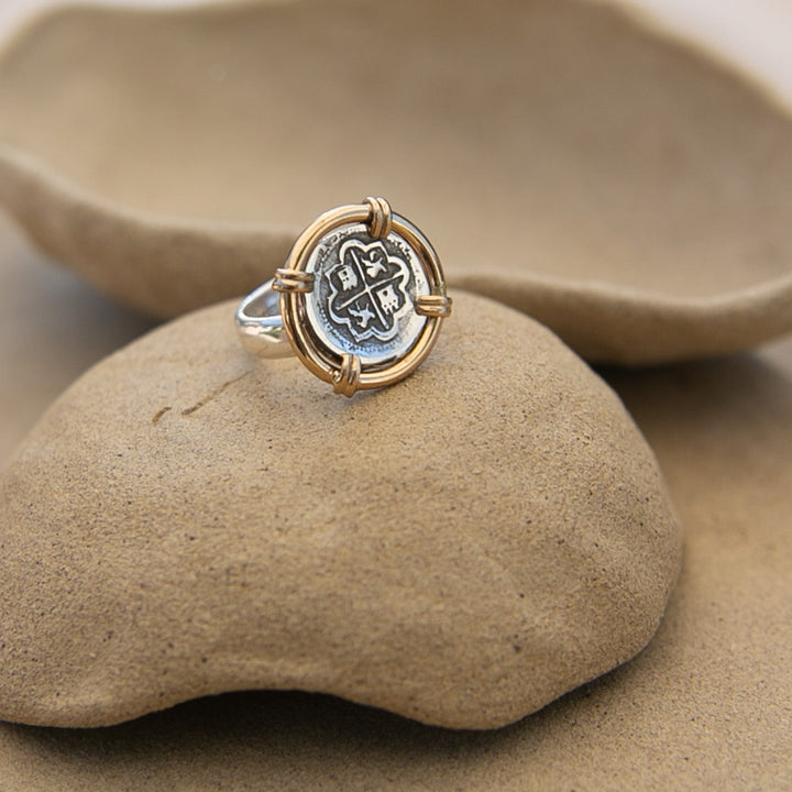 old silver coin ring with gold around it