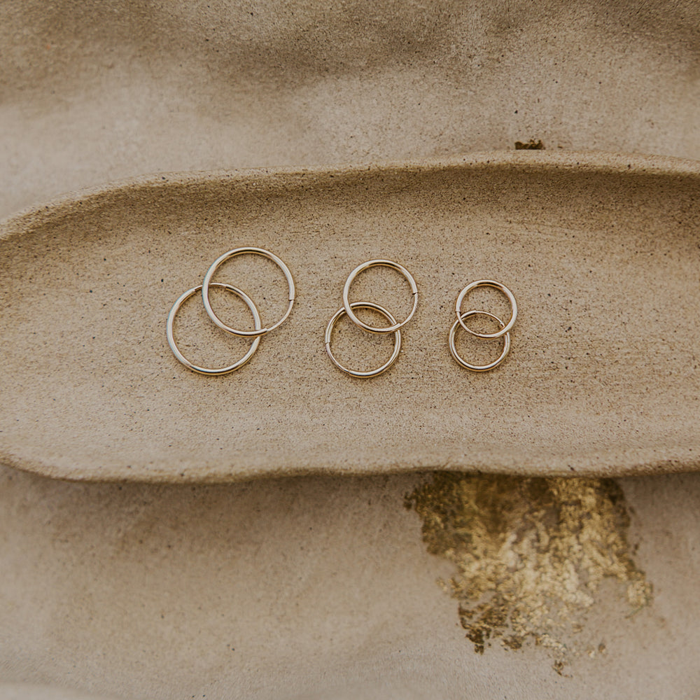 Three pairs of 14k gold fill hoop earrings 