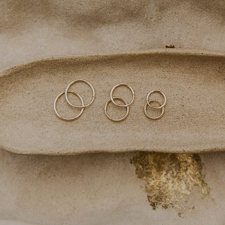 Three pairs of 14k gold fill hoop earrings 