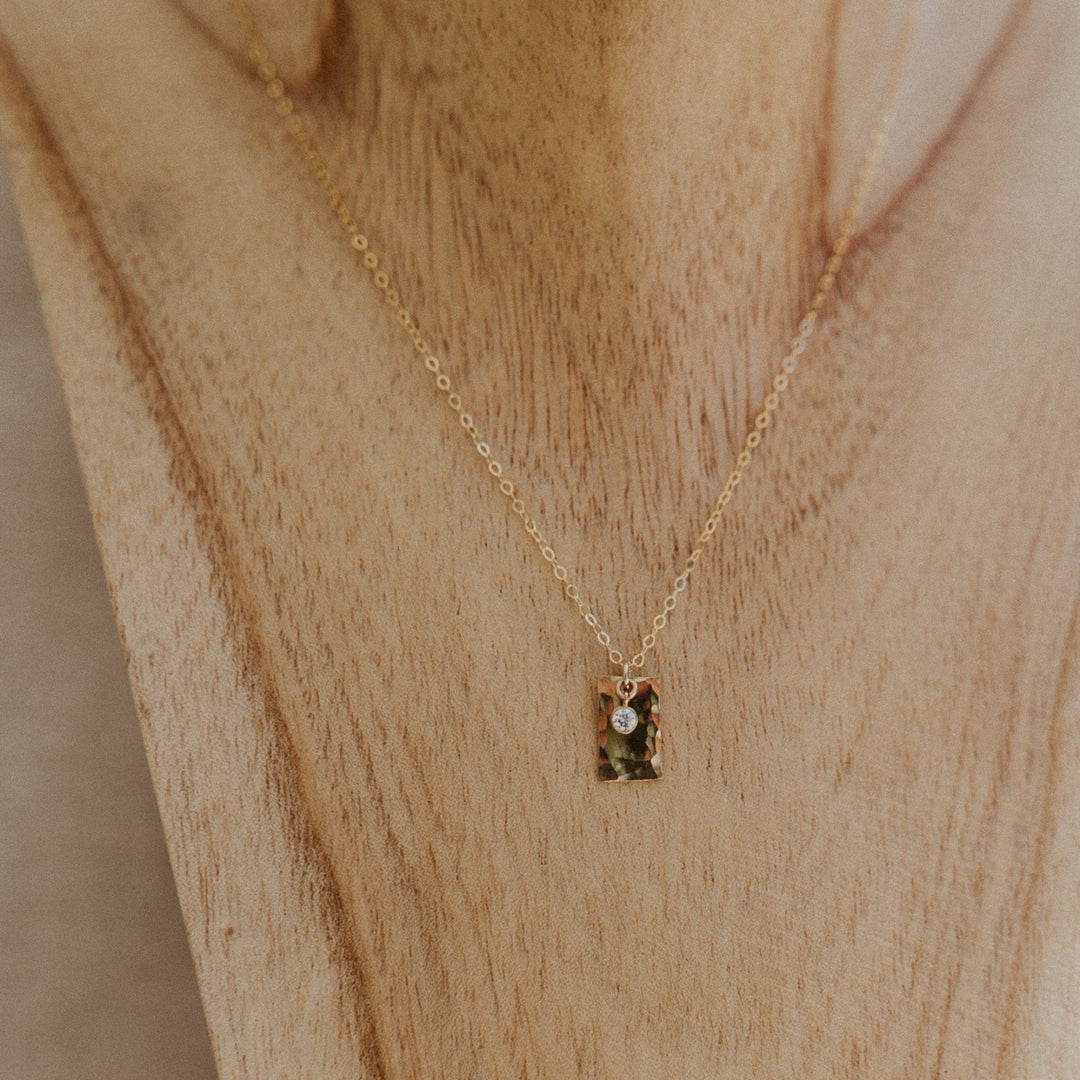Gold necklace with a 14k gold fill rectangle pendant and small diamond on gold chain 