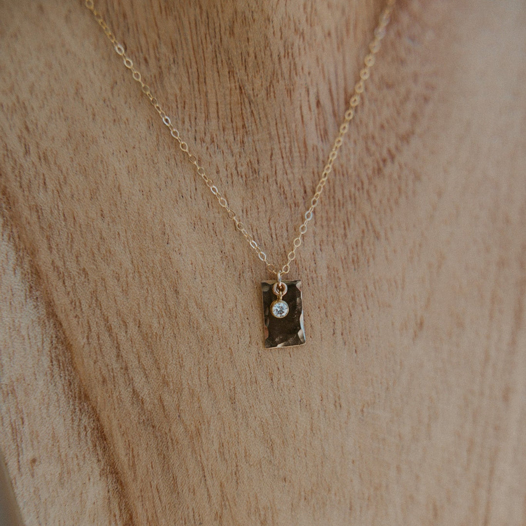 Gold necklace with a 14k gold fill rectangle pendant and small diamond on gold chain 