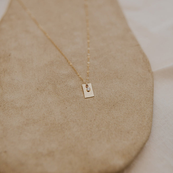 Gold necklace with a 14k gold fill rectangle pendant and small diamond on gold chain 