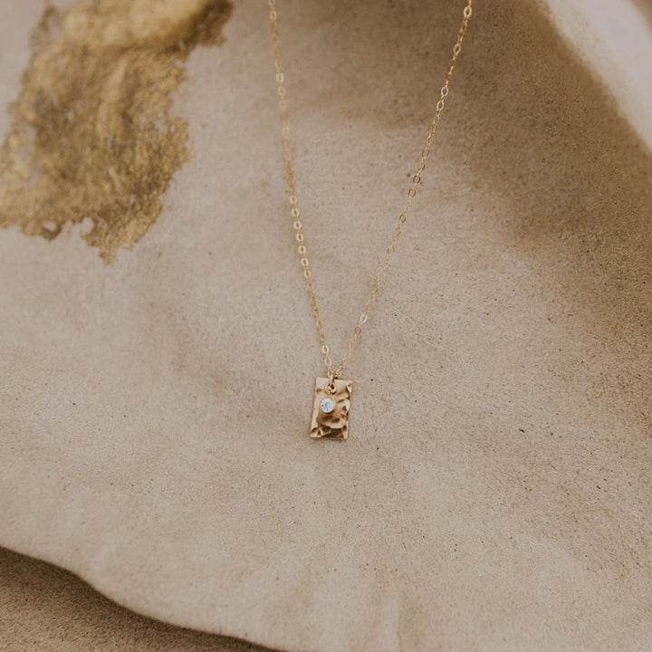 Gold necklace with a 14k gold fill rectangle pendant and small diamond on gold chain 