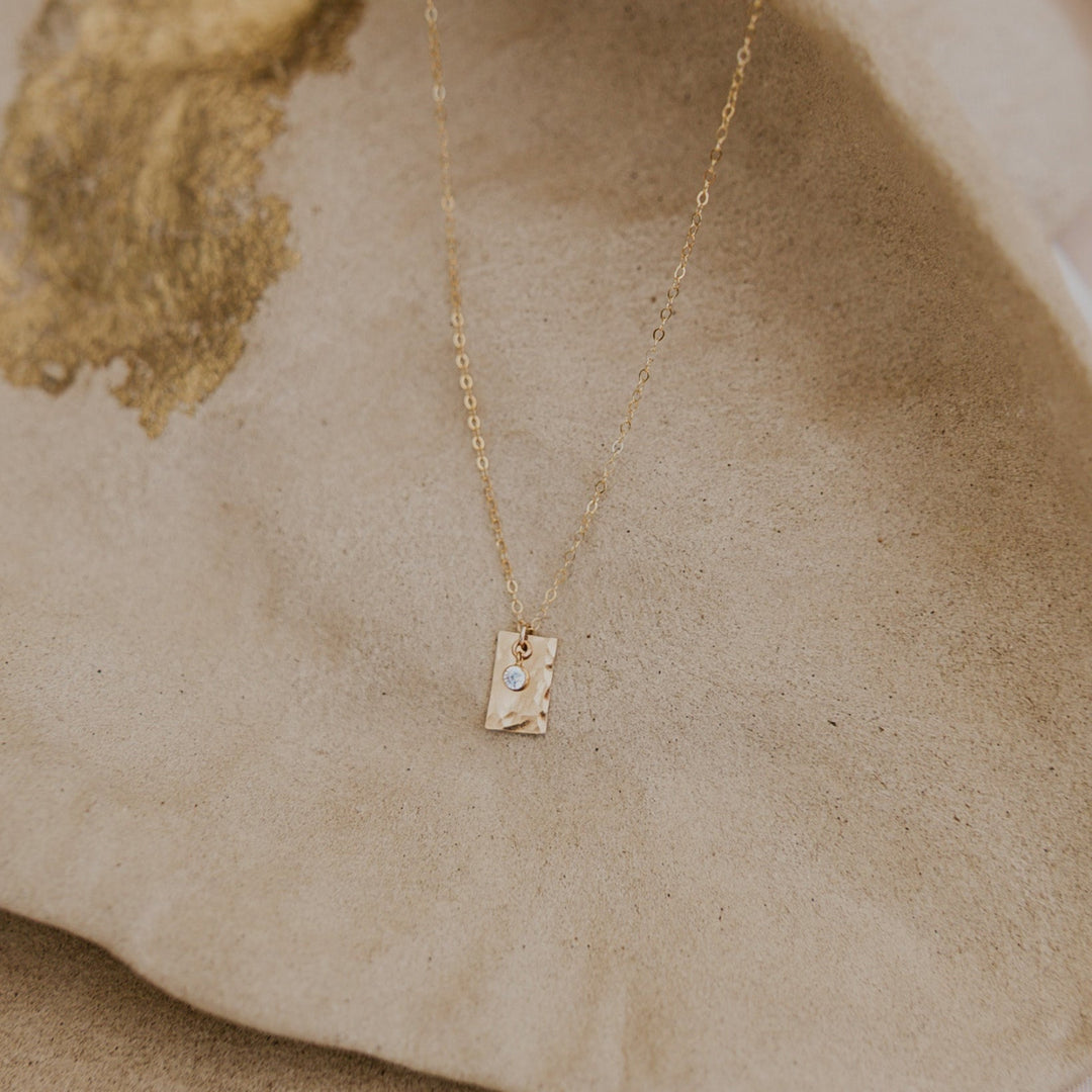 Gold necklace with a 14k gold fill rectangle pendant and small diamond on gold chain 