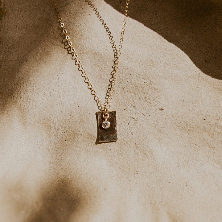 Gold necklace with a 14k gold fill rectangle pendant and small diamond on gold chain 