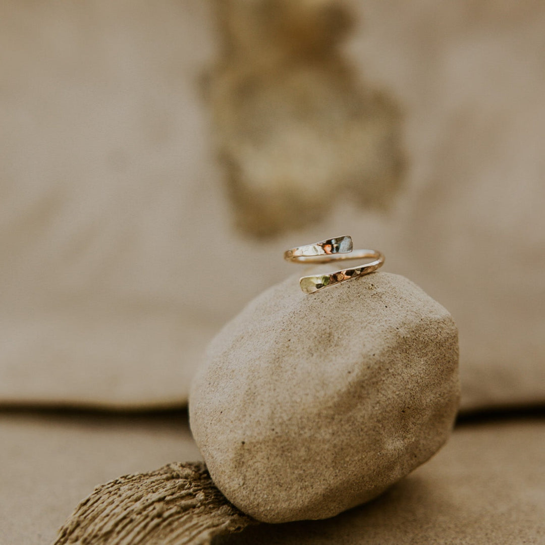 Gold ring on a stone with a blurred natural background