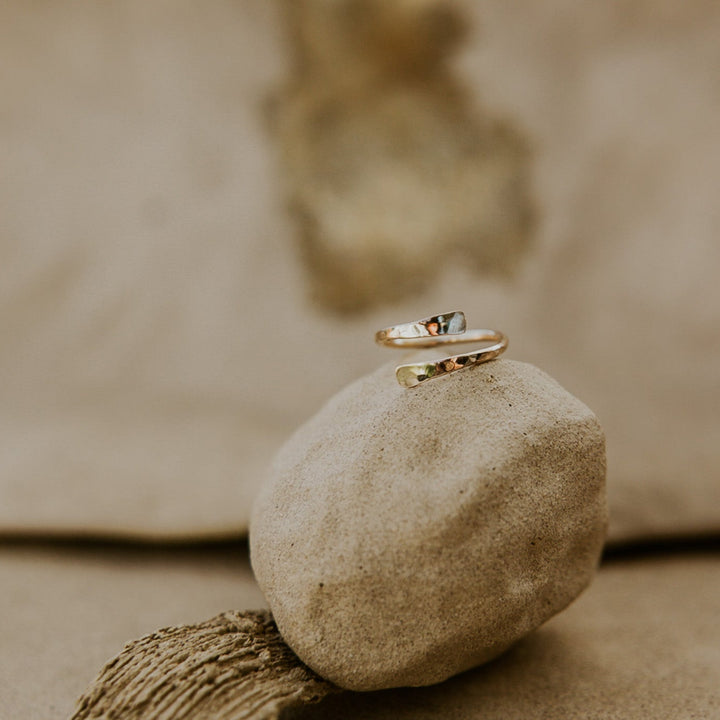 Gold ring on a stone with a blurred natural background