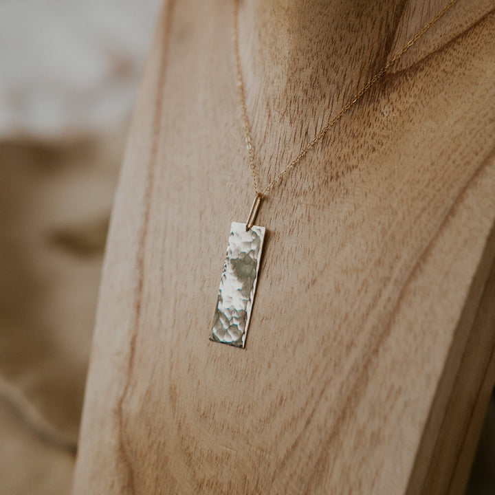 Necklace with a pendant on a wooden surface