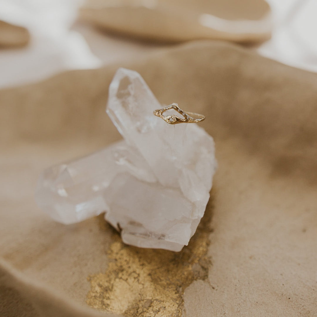 Gold ring on a clear crystal with a soft, blurred background