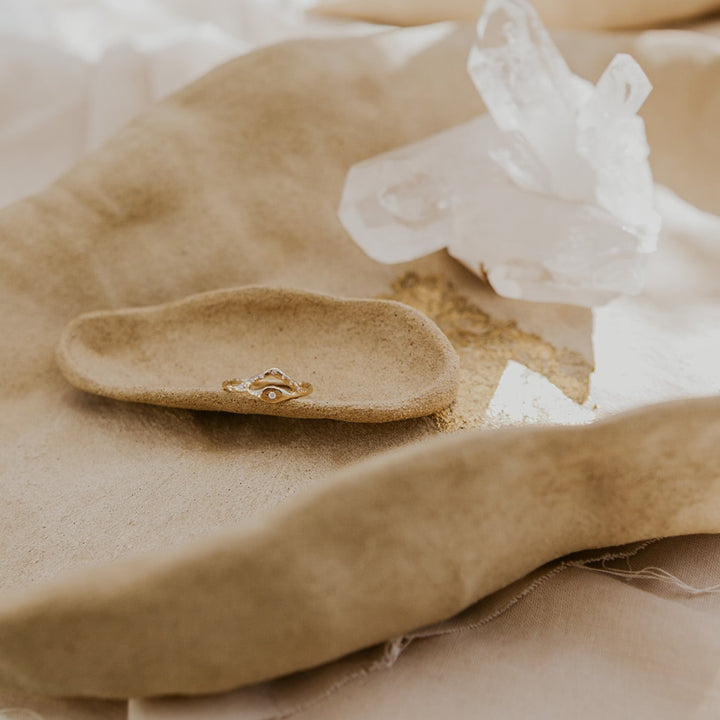 Gold ring on a brown fabric background