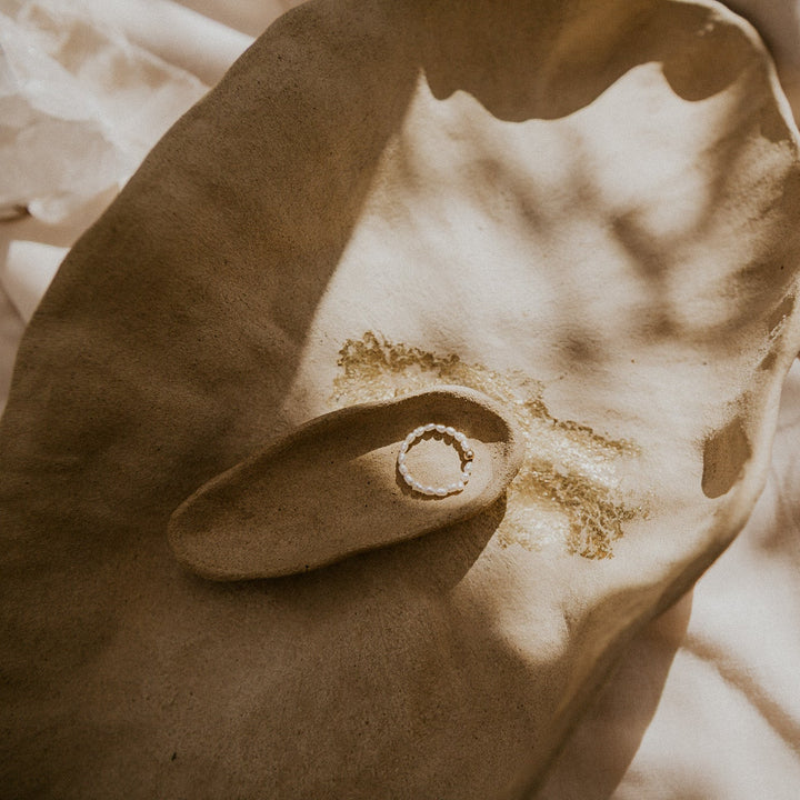 pearl ring with gold bead in the center