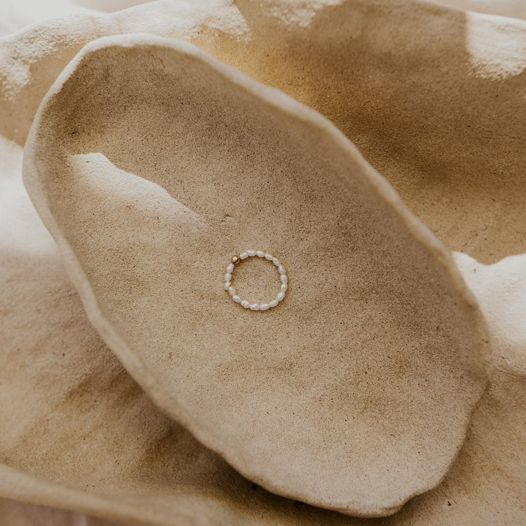 pearl ring with gold bead in center