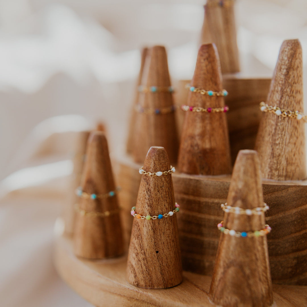 Wooden cones with jewelry on a wooden stand