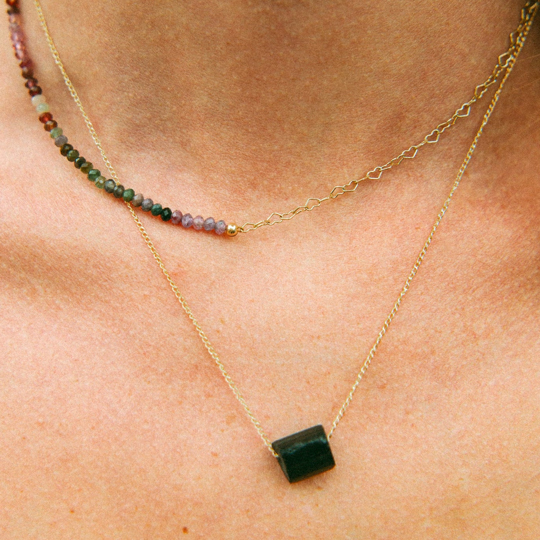 Close-up of Aurora Necklace featuring radiant multi-color spinel gemstones on gold chain.