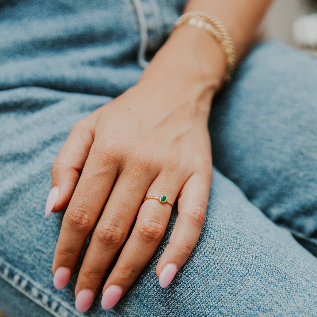 delicate 14k gold band with green emerald gemstone