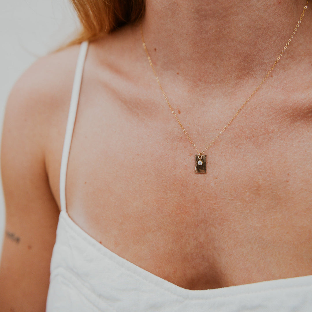 Gold necklace with a 14k gold fill rectangle pendant and small diamond on gold chain 