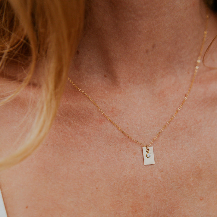 Gold necklace with a 14k gold fill rectangle pendant and small diamond on gold chain 