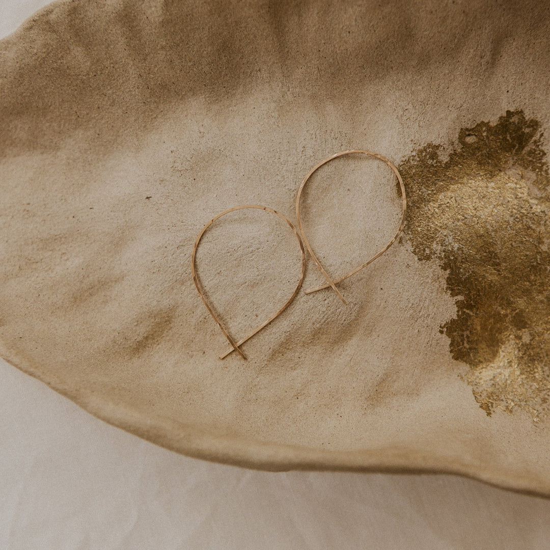 Heart-shaped object on a textured beige surface