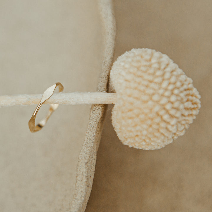 diamond hammered Gold ring on a beige stone with a textured beige sphere