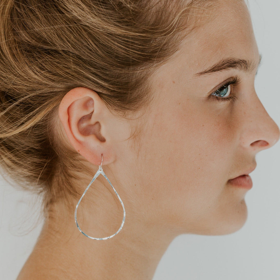 teardrop silver earrings on model