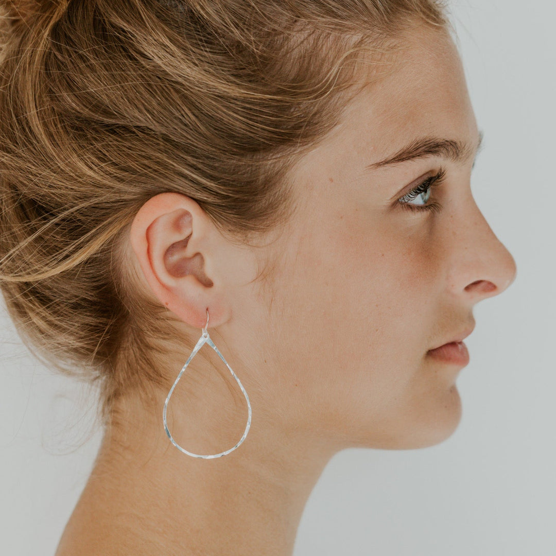 teardrop silver earrings on model