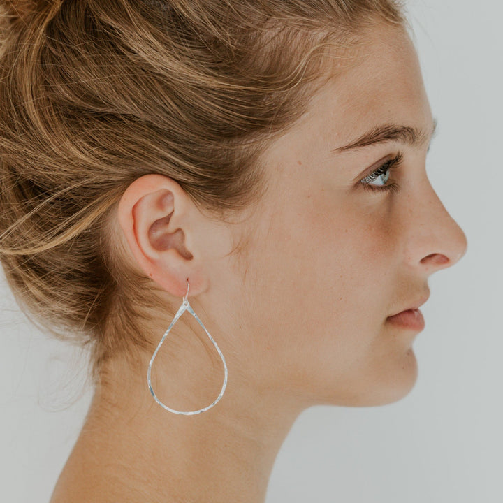 teardrop silver earrings on model