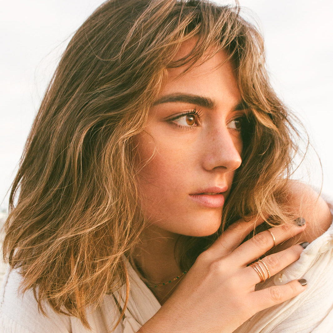 Woman wearing triple wrap gold ring 