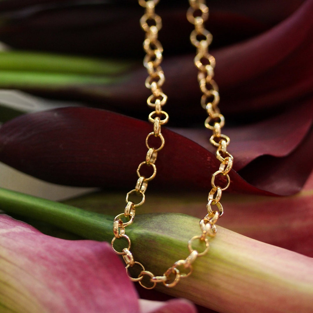 Amelia necklace in substantial 14k gold filled rolo chain draped over burgundy calla lilies