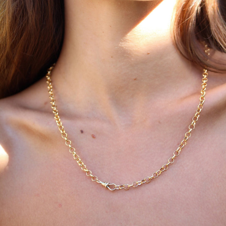 Close-up of the Amelia gold filled chain necklace on the collarbone with its swivel clasp worn at the front