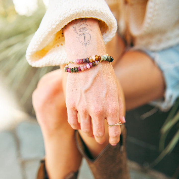 Teressa Lane Jewelry custom gemstone bracelet Carlsbad worn on a hand with a stylish outfit