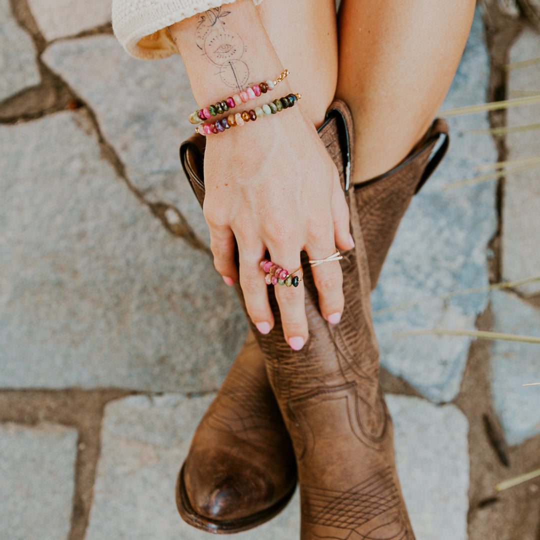 Teressa Lane Jewelry custom gemstone bracelet Carlsbad and matching necklace set worn with stylish boots