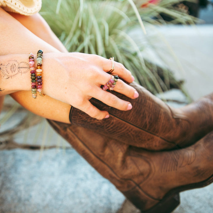 Stylish Teressa Lane Jewelry Emma gemstone ring showcased on a hand adorned with colorful bracelets