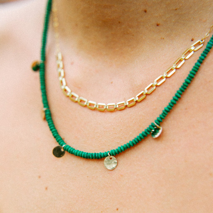 Farrah gold necklace layered with vibrant green beads for a stylish and trendy look