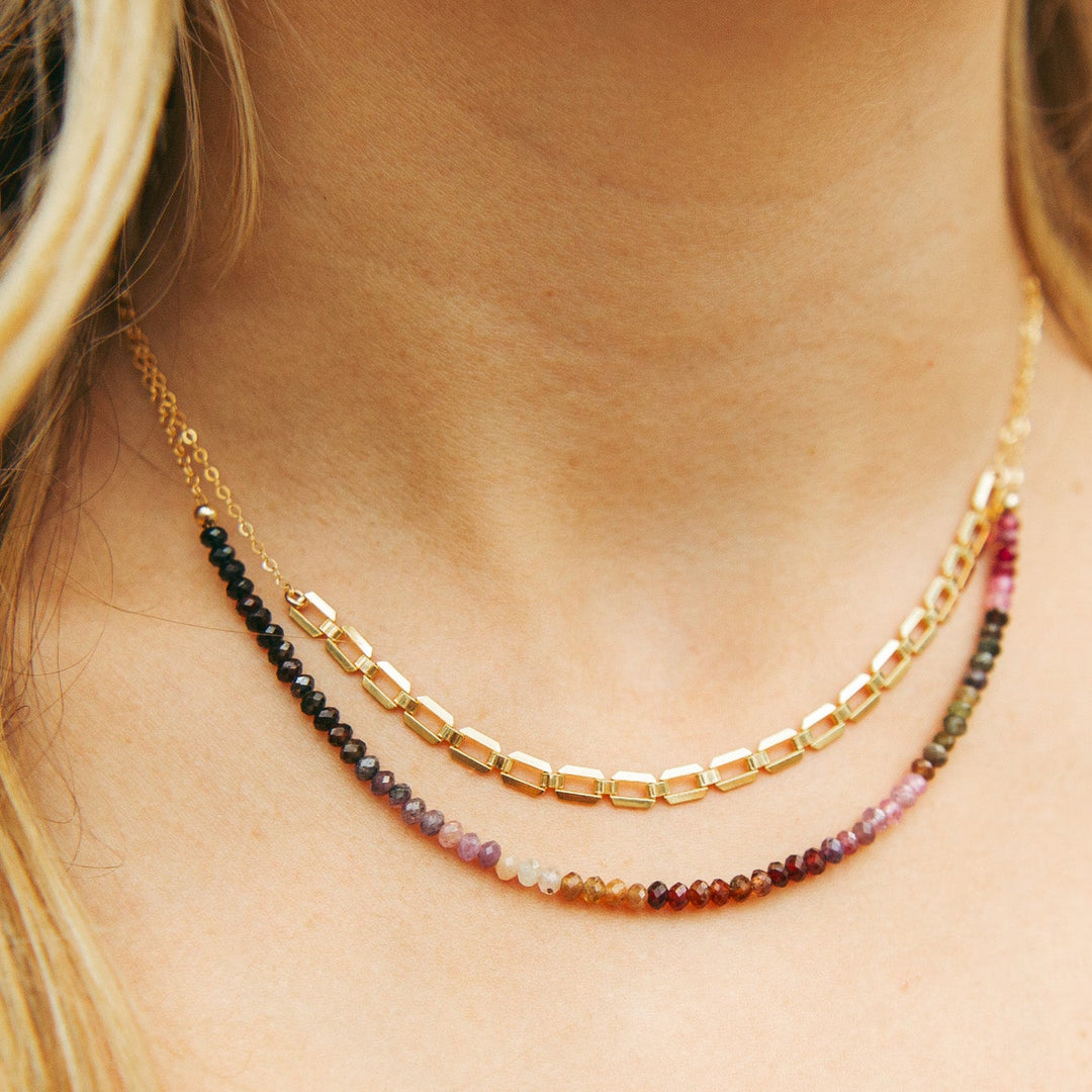 Farrah gold necklace with layered design featuring colorful gemstone beads and gold links