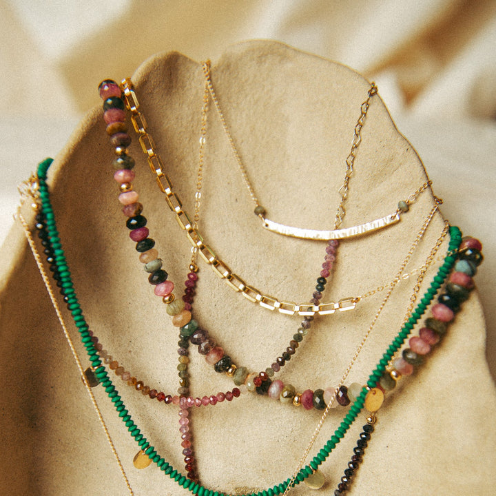 Farrah gold necklace layered with colorful beads and gold chains for a stylish look