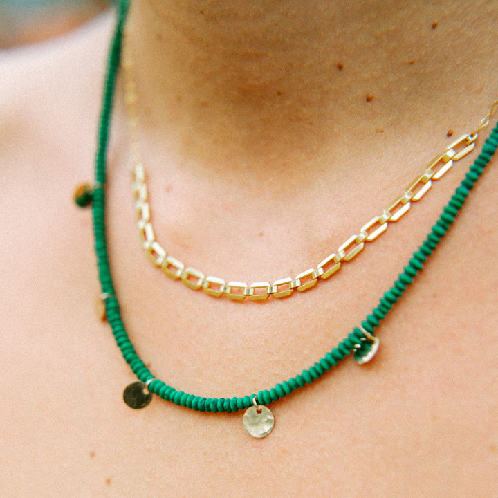 Teressa Lane Jewelry green beaded gold charm necklace adorned with delicate gold charms