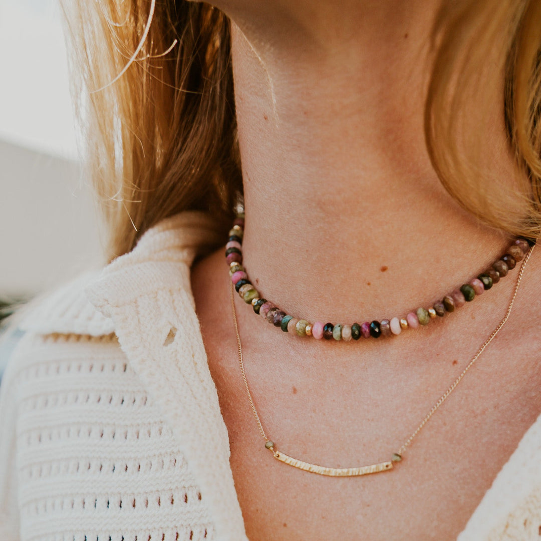 Handmade gold bar necklace layered with colorful gemstone beads for a stylish look