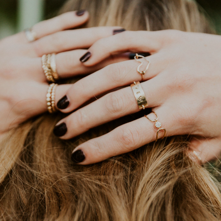 Teressa Lane Jewelry handmade stacking ring set on fingers with gold and delicate designs
