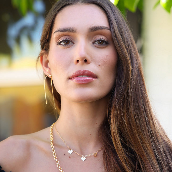 Heart charm necklace layered with the Vivienne gold filled chain, styled with gold bow drop earrings