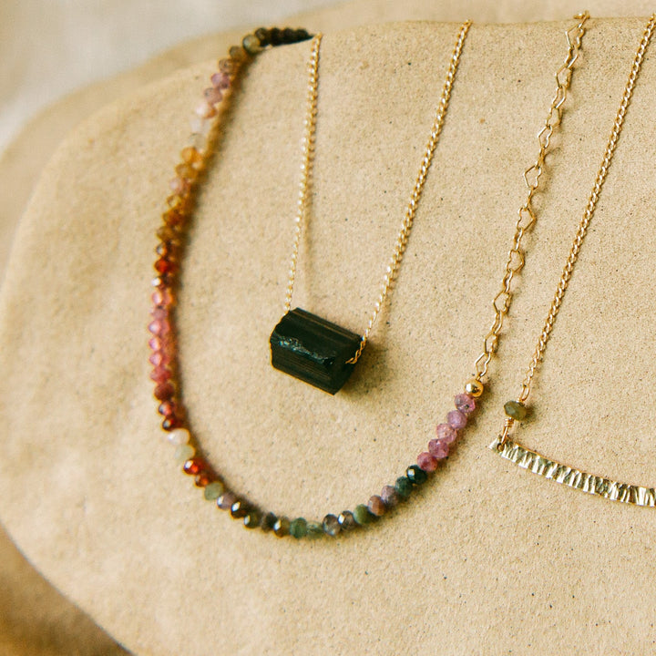 Teressa Lane Jewelry color gradient gemstone necklace with gold chain and black pendant