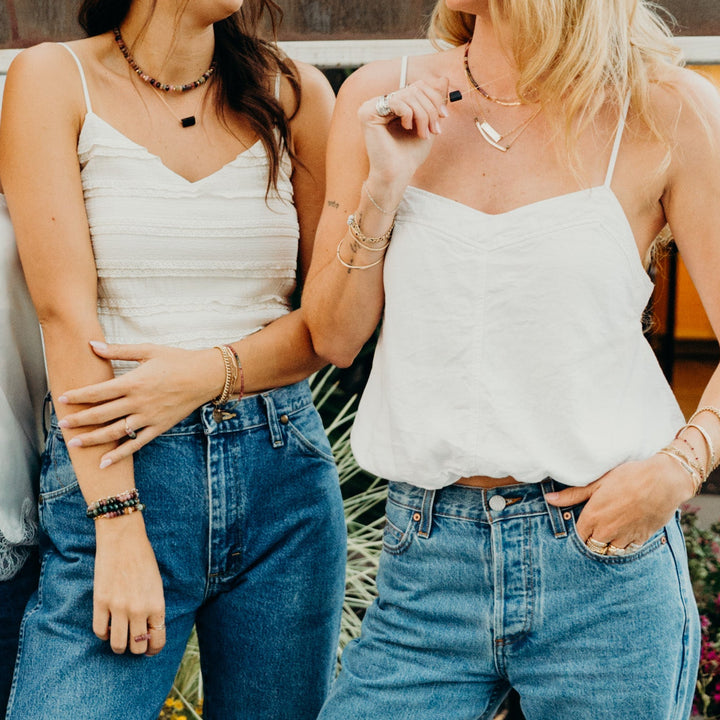Teressa Lane Jewelry layered necklaces showcased on two models in casual outfits