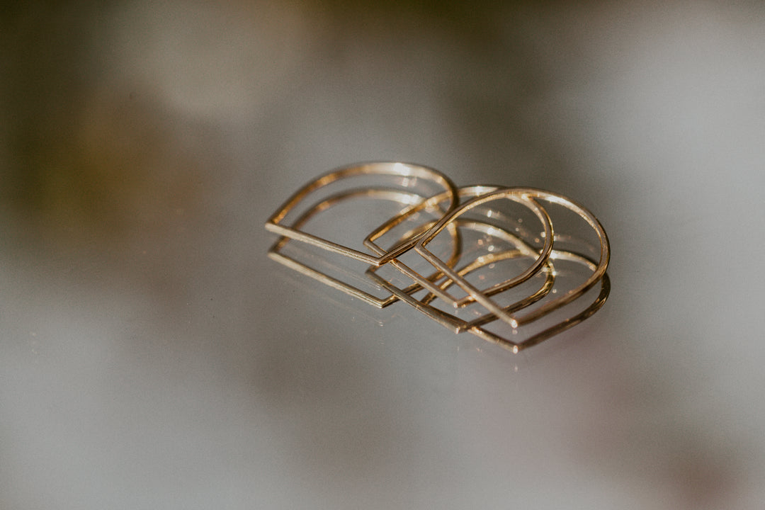 3 hand shaped Remi gold rings on mirror