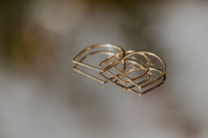 3 hand shaped Remi gold rings on mirror